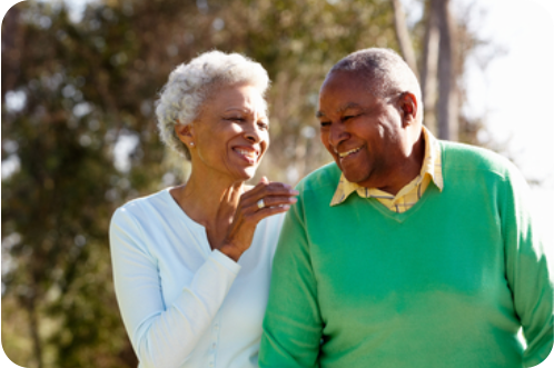 A young man is standing on a tennis court holding his shoulder and grimacing in pain. In his other hand he is holding a tennis racquet.