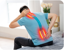 A senior man and woman outside on a sunny day. The man is leaning on a walker, and the woman is holding his arm affectionately. There are a lot of trees and other greenery in the background.