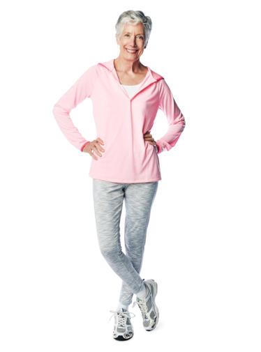 A doctor examines the knee of an elderly surgical patient who is lying on a hospital bed