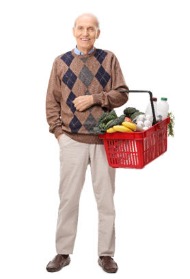 A senior man is standing on a mat doing a yoga pose with his hands over his head and his back straight.